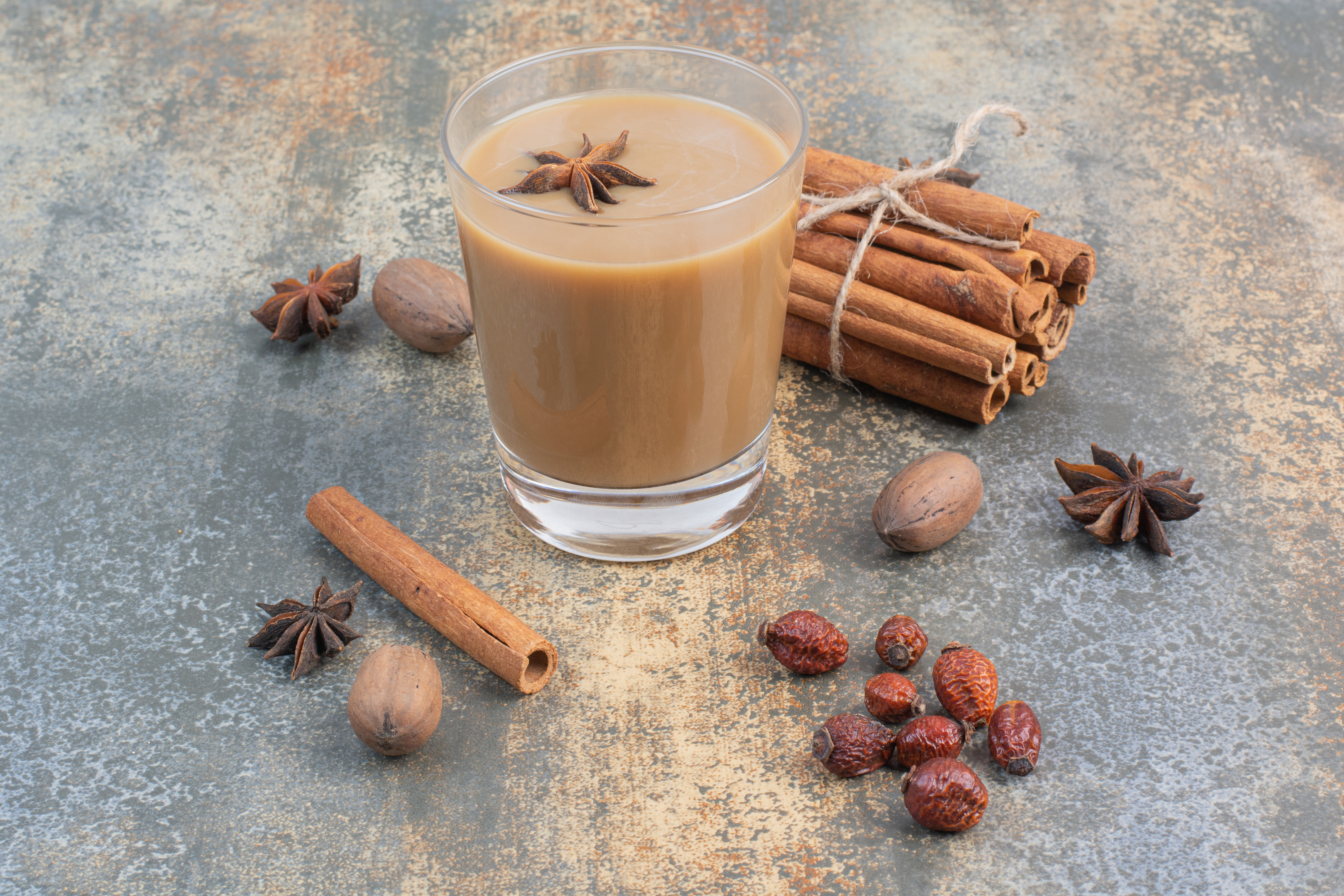 Cup of coffee with cinnamon sticks on marble background. High quality photo
