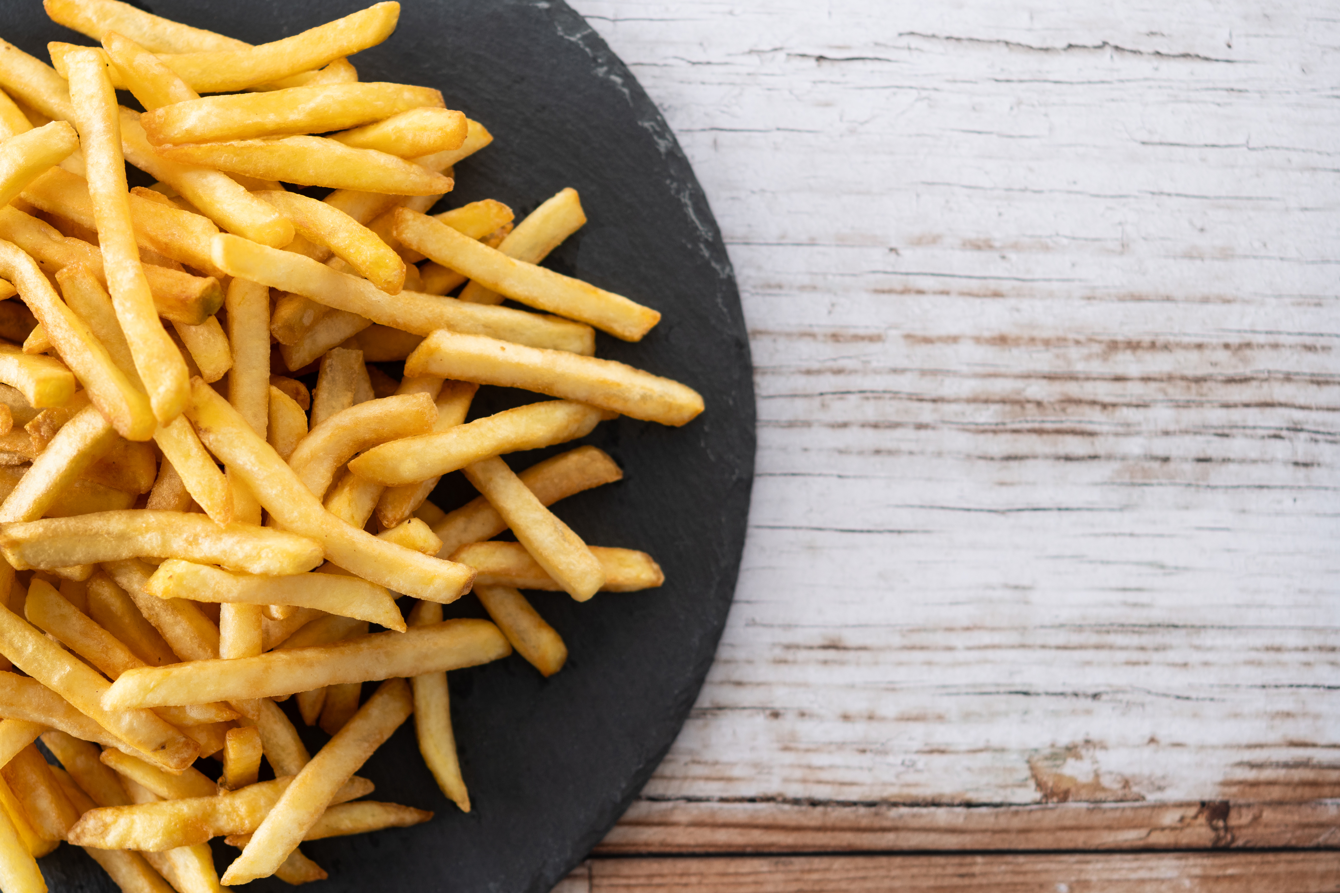 Fried potatoes, french fries on wooden table
