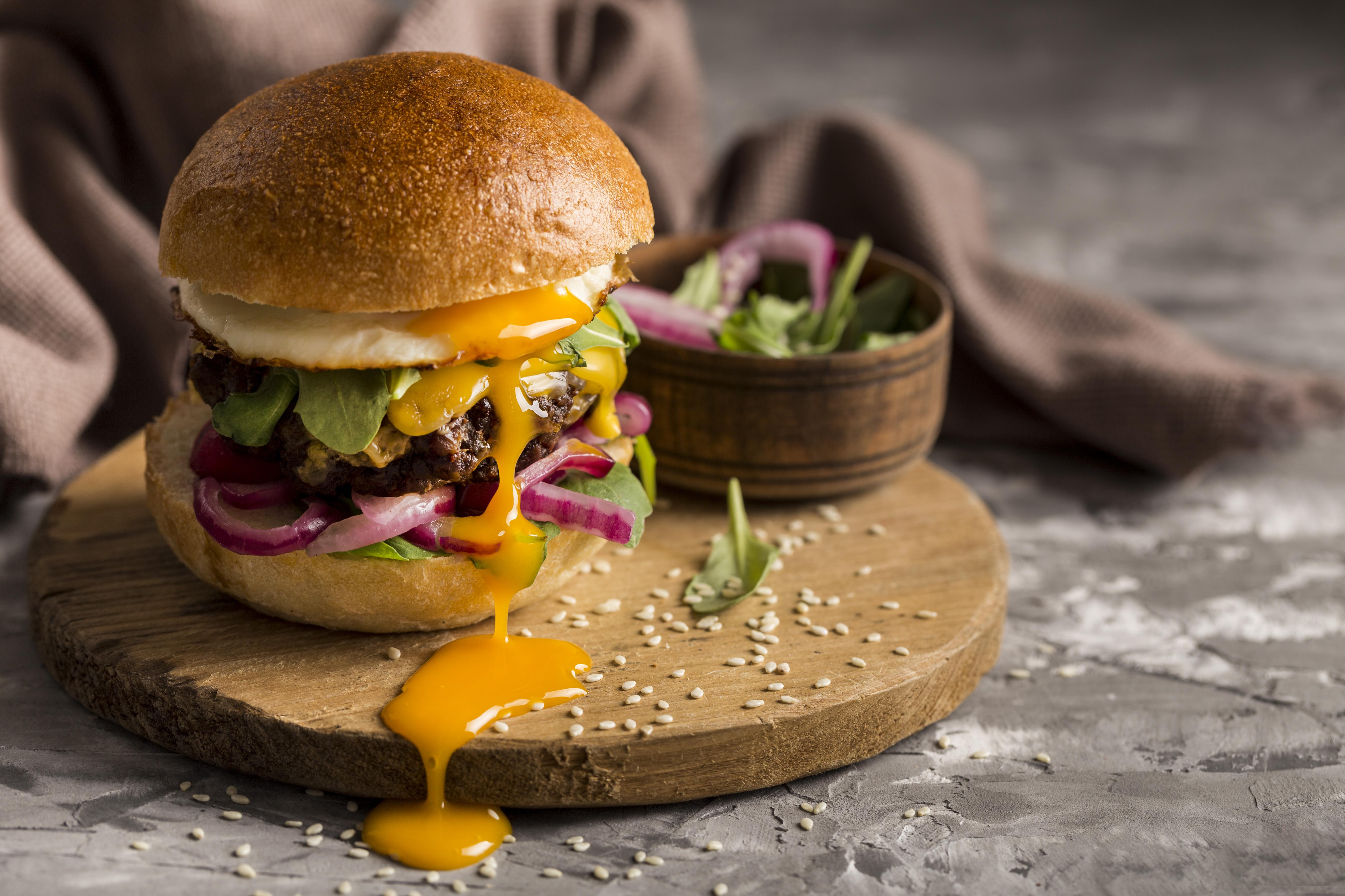 front-view-burger-with-fried-egg-cutting-board