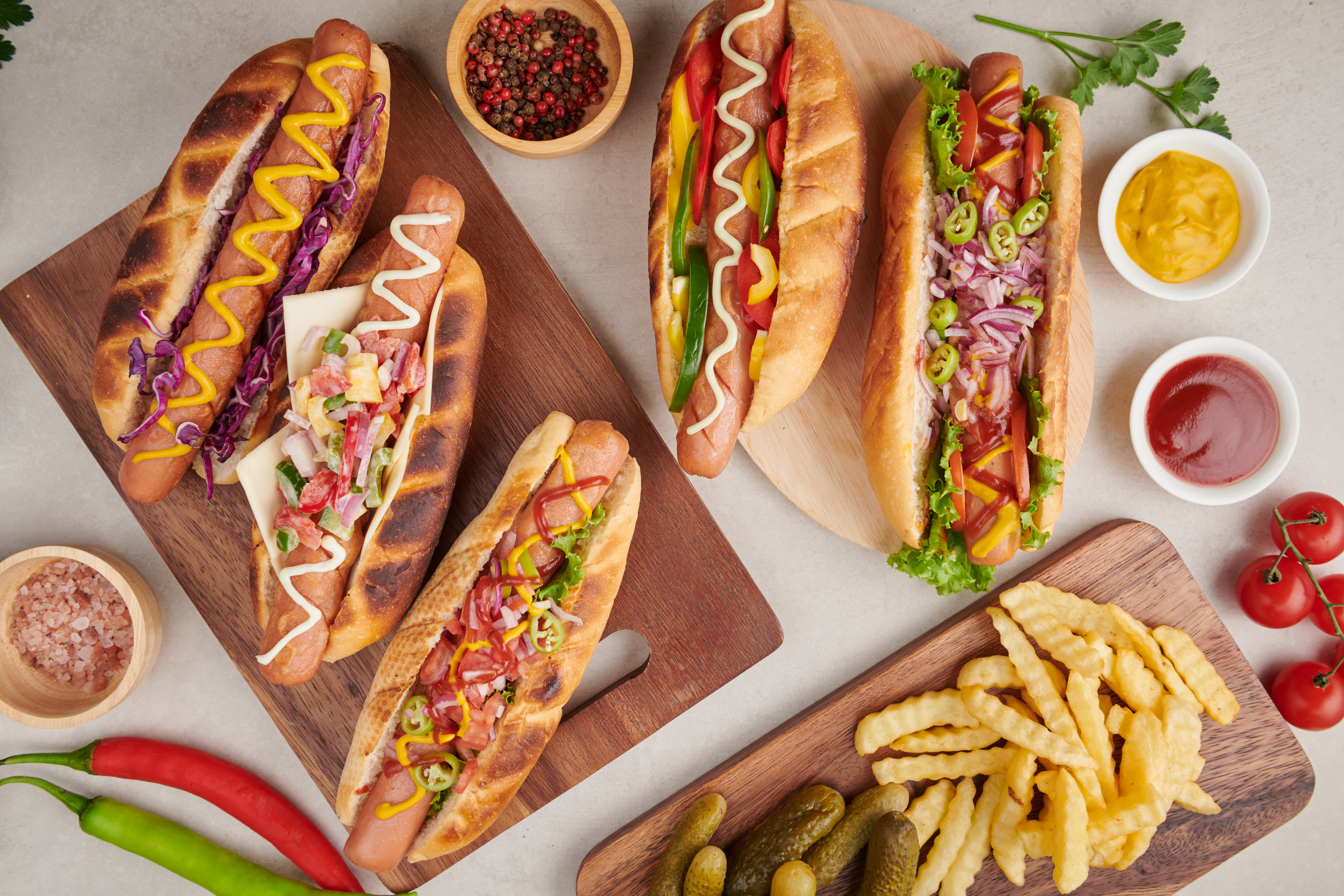 Gourmet grilled all beef hot dog with sides and chips. Delicious and simple hot dogs with mustard, pepper, onion and nachos. Hot dogs fully loaded with assorted toppings on a paddle board.